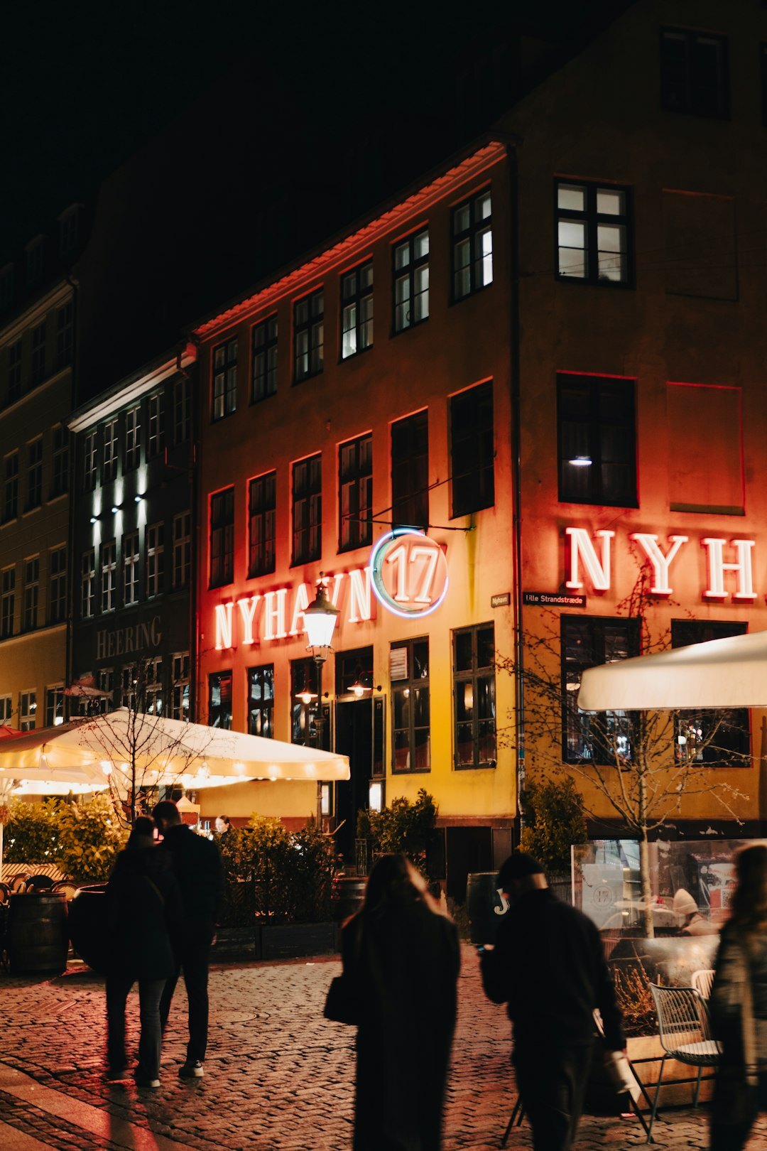 Group of Danish business people networking at an evening event with drinks